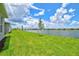 Spacious backyard features lush lawn, lake view, young trees, and peaceful surroundings at 1607 Laurel Brook Ln, Port Charlotte, FL 33953