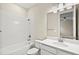 Bright bathroom with a tub-shower combo and a vanity with a large mirror at 1607 Laurel Brook Ln, Port Charlotte, FL 33953