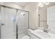 A white bathroom featuring a seamless glass shower, toilet, and sink with a large mirror at 1607 Laurel Brook Ln, Port Charlotte, FL 33953