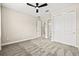 Bright bedroom featuring a ceiling fan, closet, and an ensuite bathroom at 1607 Laurel Brook Ln, Port Charlotte, FL 33953