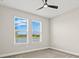 An interior view of a bedroom with neutral colors and a view of the lake at 1607 Laurel Brook Ln, Port Charlotte, FL 33953
