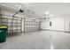 Spacious garage with an epoxy floor, overhead storage, and multiple garage doors at 1607 Laurel Brook Ln, Port Charlotte, FL 33953