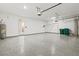 Garage featuring an epoxy floor, overhead storage, and a water heater at 1607 Laurel Brook Ln, Port Charlotte, FL 33953