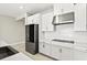 Well-lit kitchen showcasing white cabinets, stainless steel appliances, and a modern backsplash at 1607 Laurel Brook Ln, Port Charlotte, FL 33953