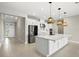 Stylish kitchen boasts a center island, stainless steel appliances, and sleek white cabinetry at 1607 Laurel Brook Ln, Port Charlotte, FL 33953