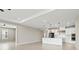 Bright, open kitchen with white cabinetry, tiled backsplash, large island with pendant lighting and modern appliances at 1607 Laurel Brook Ln, Port Charlotte, FL 33953