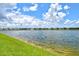 Scenic lake view with fountain and clear blue skies offers a tranquil and picturesque setting at 1607 Laurel Brook Ln, Port Charlotte, FL 33953