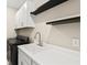 Functional laundry area with modern appliances, counter space, and floating shelves at 1607 Laurel Brook Ln, Port Charlotte, FL 33953