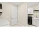 Bright laundry room with white cabinets, countertop space, and modern appliances at 1607 Laurel Brook Ln, Port Charlotte, FL 33953
