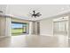 Spacious living room with sliding glass doors to a screened lanai and a water view at 1607 Laurel Brook Ln, Port Charlotte, FL 33953