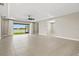 Spacious living room with a sliding glass door leading to outdoor lake view and tile flooring at 1607 Laurel Brook Ln, Port Charlotte, FL 33953