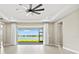 Spacious living room with sliding glass doors leading to a screened lanai overlooking the water at 1607 Laurel Brook Ln, Port Charlotte, FL 33953