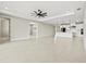 Spacious living room with an open floor plan, a modern kitchen, and a ceiling fan at 1607 Laurel Brook Ln, Port Charlotte, FL 33953