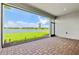 Screened patio with brick floors and a view of the yard and pond at 1607 Laurel Brook Ln, Port Charlotte, FL 33953