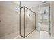A modern glass enclosed walk-in shower featuring a tiled wall and floor at 1607 Laurel Brook Ln, Port Charlotte, FL 33953