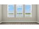 This is a view of the backyard lake from the house's interior, seen through three adjacent windows at 1607 Laurel Brook Ln, Port Charlotte, FL 33953