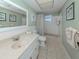 Bathroom featuring a single sink vanity, toilet, tub, and tiled floors at 168 The Corso # 168, Venice, FL 34285