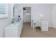 Bedroom with white wicker desk and furniture with a large walk-in closet at 168 The Corso # 168, Venice, FL 34285