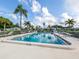 Relaxing community pool surrounded by lounge chairs and palm trees, offering a perfect spot to unwind at 168 The Corso # 168, Venice, FL 34285