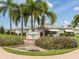 Beach Manor Villas 55+ Community Sign with colorful foliage and lush landscaping at 168 The Corso # 168, Venice, FL 34285