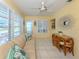 Bright living room with a comfortable sofa, tile flooring, and large windows at 168 The Corso # 168, Venice, FL 34285