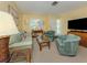 Cozy living room with neutral carpet, matching furniture, and modern entertainment setup at 168 The Corso # 168, Venice, FL 34285