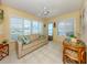 Bright living room with large windows, a comfortable sofa, and tile flooring at 168 The Corso # 168, Venice, FL 34285