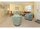 Inviting living room featuring a seating arrangement, neutral carpet, and bright natural light at 168 The Corso # 168, Venice, FL 34285