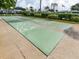 Outdoor shuffleboard courts, ready for a friendly game in a well-maintained community space at 168 The Corso # 168, Venice, FL 34285