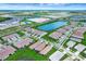 An aerial view of a community showcasing numerous homes, green spaces, and water features at 17873 Grand Prosperity Dr, Venice, FL 34293