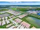 Stunning aerial view of a community with diverse amenities and lush greenery throughout the landscape at 17873 Grand Prosperity Dr, Venice, FL 34293