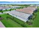 Expansive aerial view of a residential neighborhood featuring modern homes with well-kept lawns and scenic landscaping at 17873 Grand Prosperity Dr, Venice, FL 34293