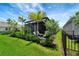 Charming backyard patio with a cozy seating area, surrounded by lush landscaping for privacy and relaxation at 17873 Grand Prosperity Dr, Venice, FL 34293