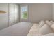 Bedroom featuring a window and closet, clean walls, and stylish wood-look floors at 17873 Grand Prosperity Dr, Venice, FL 34293