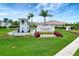 Inviting community entrance sign, surrounded by colorful flowers and manicured landscaping, welcoming residents and guests at 17873 Grand Prosperity Dr, Venice, FL 34293