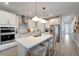 Modern kitchen featuring an island with seating, stainless steel appliances, and pendant lighting at 17873 Grand Prosperity Dr, Venice, FL 34293