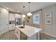 Kitchen island with modern finishes, quartz countertop, stainless steel appliances, and natural light at 17873 Grand Prosperity Dr, Venice, FL 34293