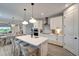 Stylish kitchen with quartz island, stainless steel appliances, and elegant pendant lighting at 17873 Grand Prosperity Dr, Venice, FL 34293