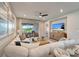 Inviting living room with cozy seating, a ceiling fan, and an open view to the outdoor patio area at 17873 Grand Prosperity Dr, Venice, FL 34293