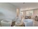 This living room has several chairs arranged around a round table and an adjacent dining room at 17873 Grand Prosperity Dr, Venice, FL 34293