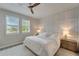 Serene main bedroom with wood-look flooring, decorative wall paneling, and bright natural light at 17873 Grand Prosperity Dr, Venice, FL 34293