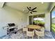 Lanai with outdoor grill and dining table and seating at 17873 Grand Prosperity Dr, Venice, FL 34293