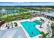 Resort style community pool featuring lounge chairs, palm trees and a covered seating area at 17873 Grand Prosperity Dr, Venice, FL 34293