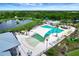 Gorgeous resort-style community pool with ample seating, palm trees, and shaded lounging areas at 17873 Grand Prosperity Dr, Venice, FL 34293