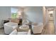 Cozy sitting room with comfortable seating, stylish decor, and natural light from a window at 17873 Grand Prosperity Dr, Venice, FL 34293