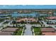 An aerial view of the community clubhouse featuring a pool, tennis, and lush landscaping at 19269 Serafina St, Venice, FL 34293