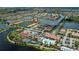 Aerial view of residential area featuring several homes, lakes, community pool and clubhouse amenities at 19269 Serafina St, Venice, FL 34293