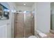 This bathroom showcases a glass-enclosed shower with tiled walls and features modern shower fixtures at 19269 Serafina St, Venice, FL 34293