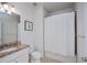 This bathroom showcases granite countertops and modern fixtures, with a shower and white shower curtain at 19269 Serafina St, Venice, FL 34293