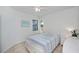 This is a bedroom featuring a ceiling fan and a view of the nearby lake at 19269 Serafina St, Venice, FL 34293